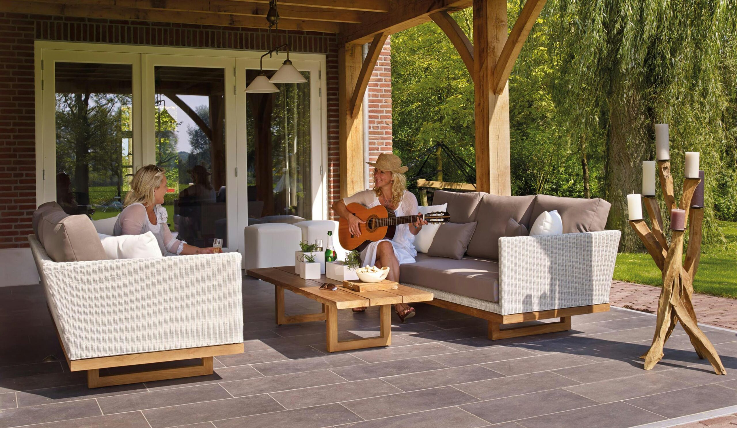 woman playing guitar for her friend in the garden